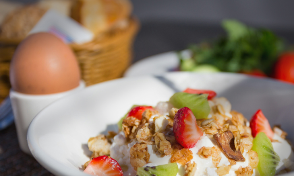 Assorted high-protein foods including eggs, oat, and greek yogurt.