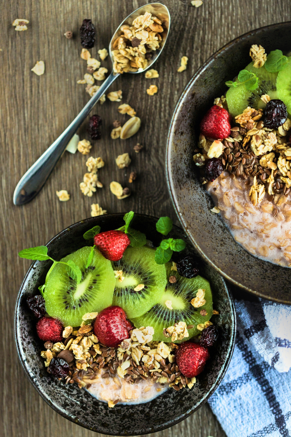 High protein bowl for breakfast sith oats, raisins, seeds, nuts, greek yogurt and fruit.
